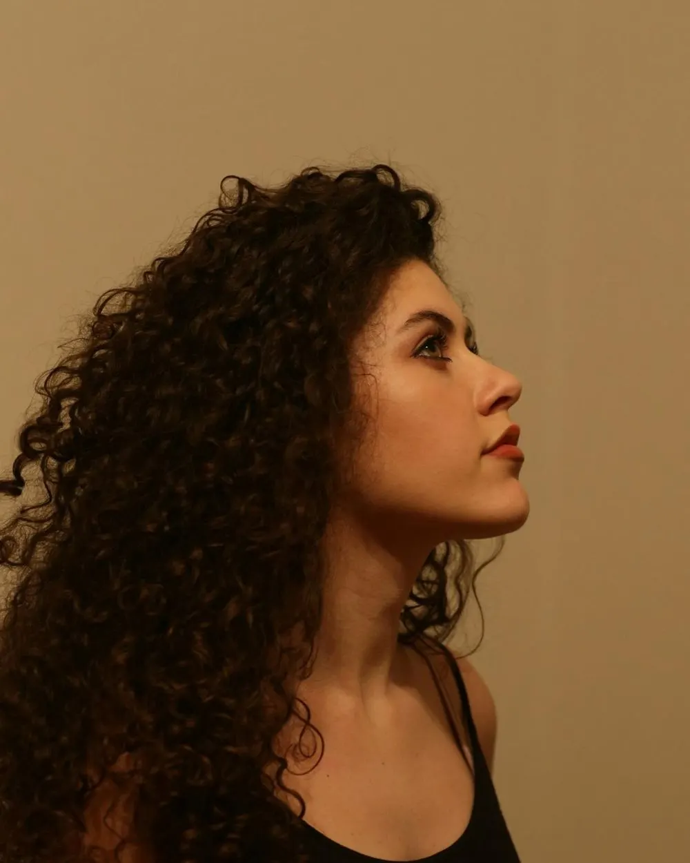 Woman with voluminous curls in warm light