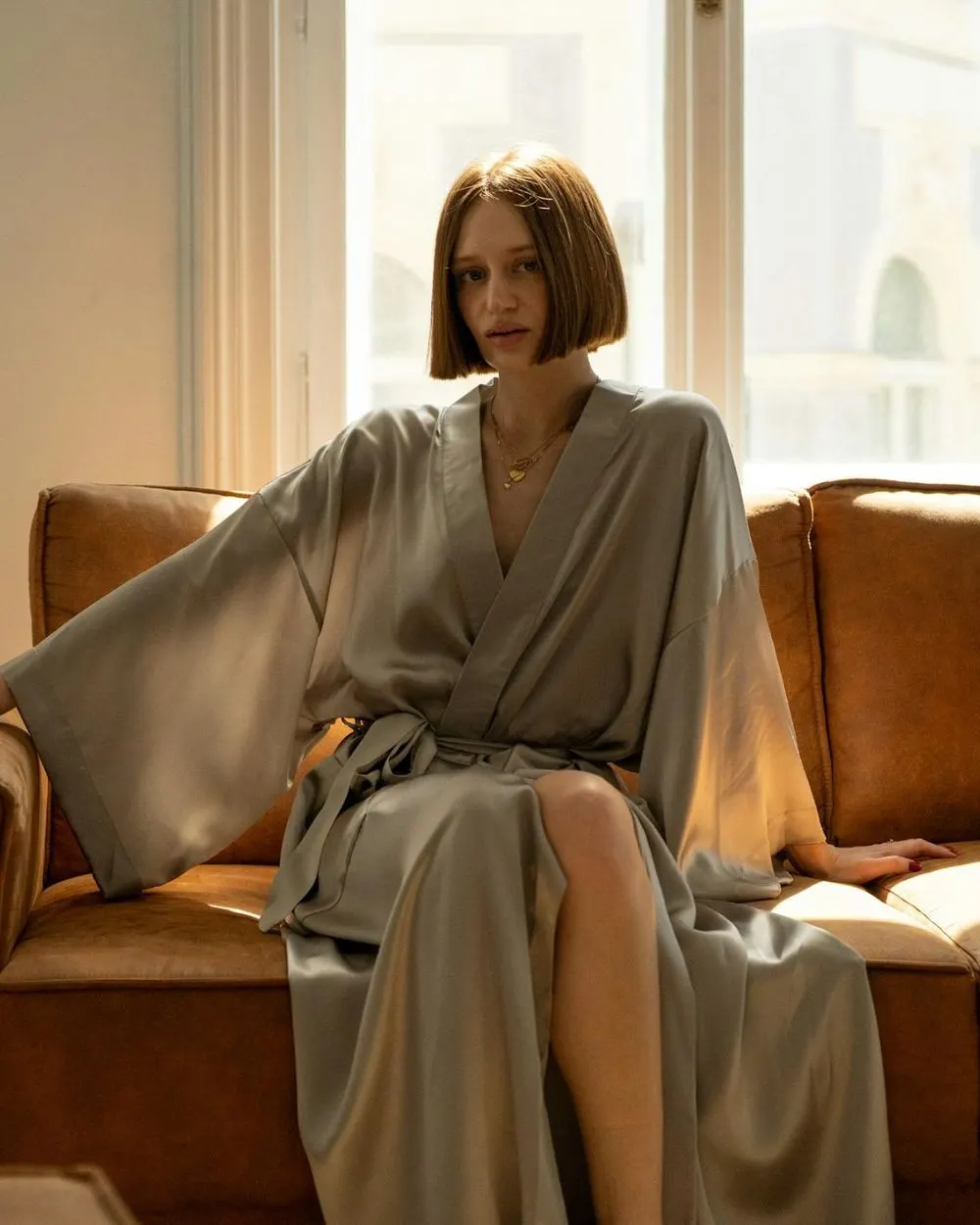 Woman in a satin kimono in morning light